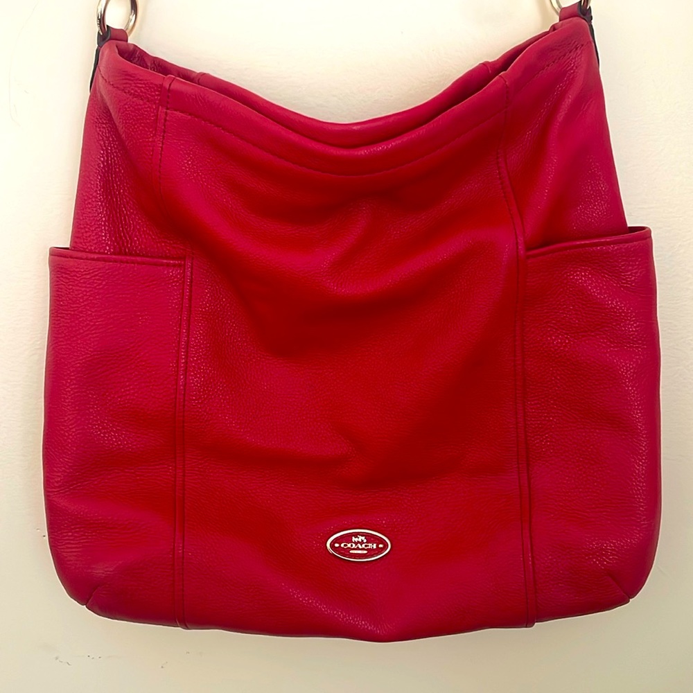 COACH oversized messenger bag in red.